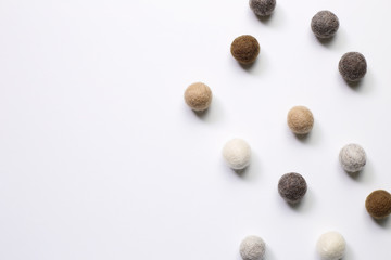 Knitted balls on white background. Winter decoration