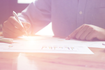 businessman working use laptop in office for discussing documents and ideas , with soft focus, vintage tone