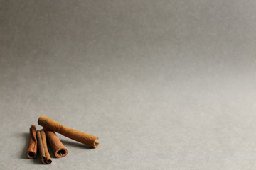 Cinnamon sticks on gray background