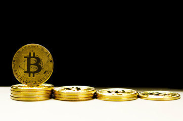 Gold bitcoins on black background.Bitcoins and New Virtual money concept.