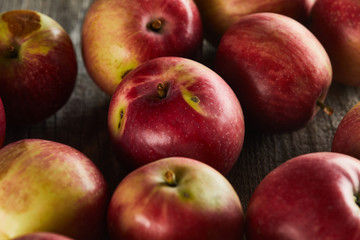 Fototapeta na wymiar red ripe apples on brown wooden surface