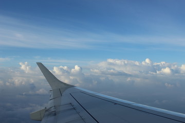 Fototapeta na wymiar Plane wing in clouds