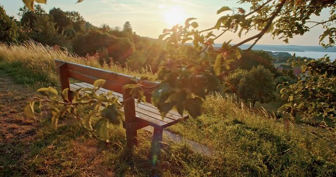 Panorama View over Village and Lake with an Empty Bench and a Setting Sun