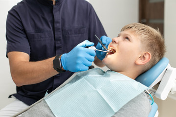 Calm dentist use mouthwash on his patient's teeths