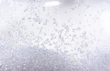 Close up of crystal sugar in Glass bottles on white background.