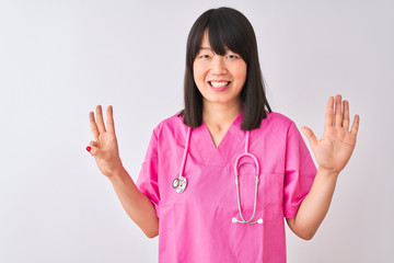 Young beautiful Chinese nurse woman wearing stethoscope over isolated white background showing and pointing up with fingers number eight while smiling confident and happy.