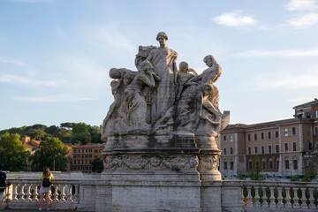 Fototapeta na wymiar Marble composition on the bridge of Victor Emmanuel II over the Tiber River in Rome, symbolizing freedom and unity.