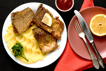 Pieces of fried fish on a served table