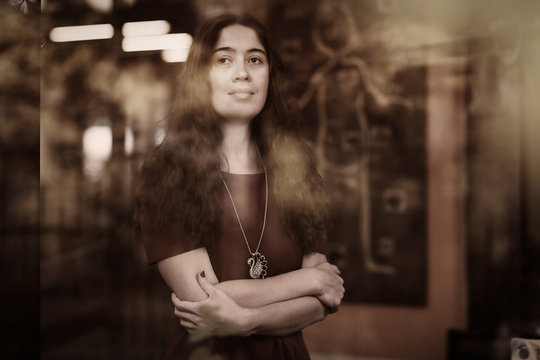 retro portrait of woman through the cafe window in decolette dress close up phot