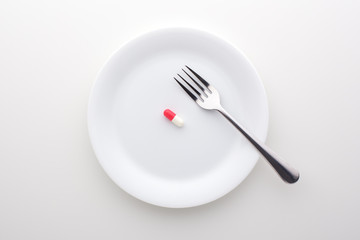 Dietary supplement on white plate