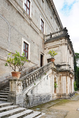 Part of a shabby medieval house with a stair and a banister of a typical Italian architecture