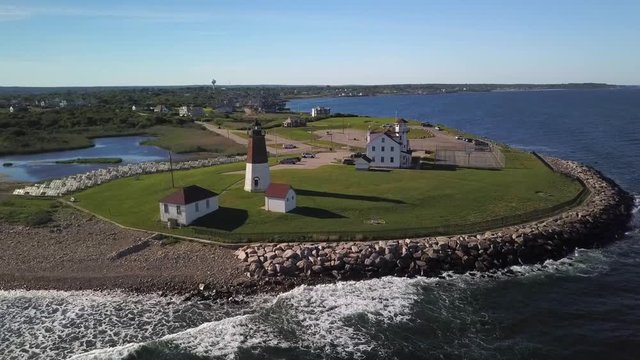 Aerial push in on Point Judith Lighthouse on the coast near Narragansett in Rhode Island