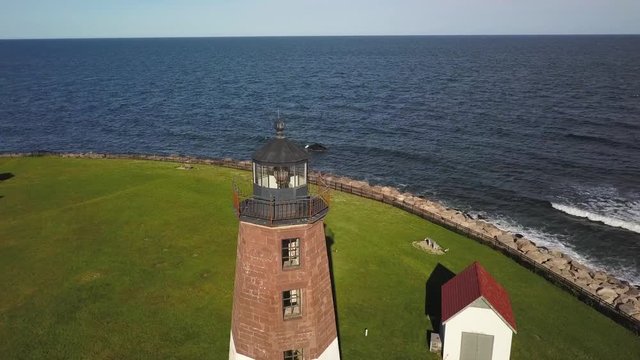 Aerial fly by orbit of Point Judith Lighthouse on the coast near Narragansett in Rhode Island