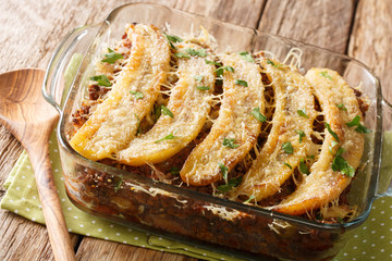 Homemade American Pastelon de Platano Maduro closeup baked in a baking dish. horizontal © FomaA