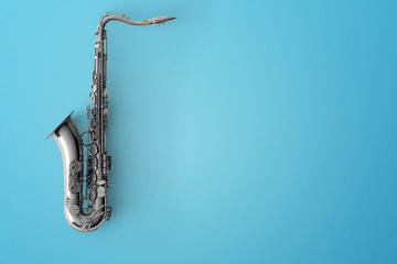 Saxophone on color background