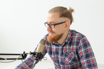 Blogger, streamer and people concept - Funny young man DJ working on the radio