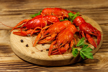 Boiled crayfish on cutting board on wooden table