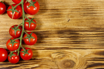 Fresh cherry tomatoes on a wooden table. Top view