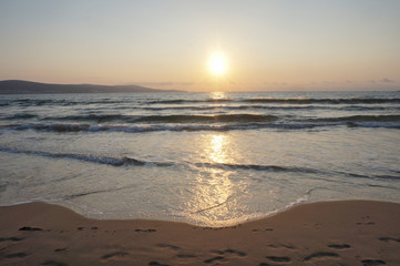 Nature in twilight period which including of sunrise over the sea and the nice beach. Summer beach with blue water and purple sky at the sunset.