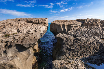 A huge rock on the shore in the form of an arch