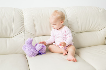 Children, infant and childhood concept - Beautiful cute soft baby sitting on sofa