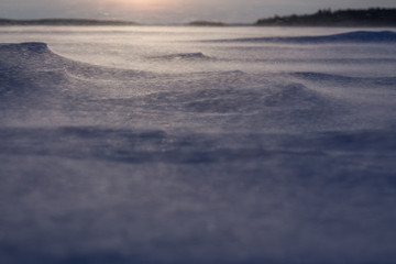 Dawn on the frozen lake. Strong wind and Blizzard. Low freezing temperature.