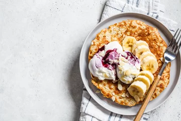 Foto op Plexiglas Sweet oatmeal pancake with banana and yogurt. Healthy breakfast concept. © vaaseenaa
