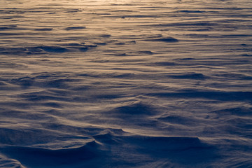 Dawn on the frozen lake. Strong wind and Blizzard. Low freezing temperature.