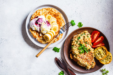 Oatmeal omelet with cheese and sweet oatmeal pancake, top view. Healthy breakfast concept.