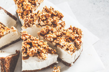 Raw vegan cashew cheesecake with caramel popcorn. Raw vegan dessert concept.