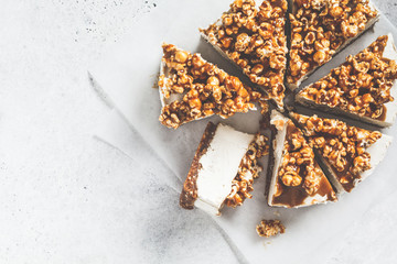 Raw vegan cashew cheesecake with caramel popcorn, top view. Raw vegan dessert concept.