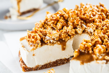 Raw vegan cashew cheesecake with caramel popcorn. Raw vegan dessert concept.