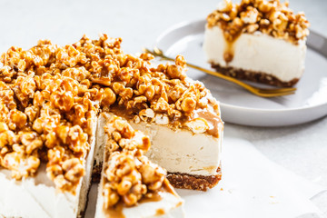 Raw vegan cashew cheesecake with caramel popcorn. Raw vegan dessert concept.
