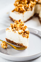 Raw vegan cashew cheesecake with caramel popcorn. Raw vegan dessert concept.