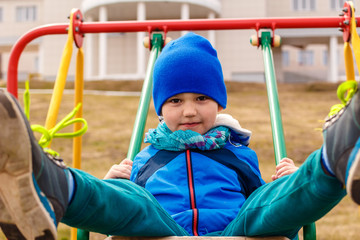 Baby rides a swing