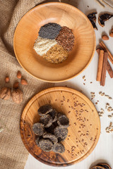 Natural homemade sweets, sugar free, with poppy seeds and sesame seeds. Diet dessert lies on a wooden tray. Healthy lifestyle.