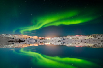 Fototapeta na wymiar Northern Lights on the shore of the Arctic Ocean.