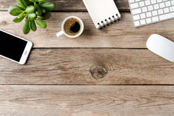 Office desktop with accessories on wooden background with copyspace