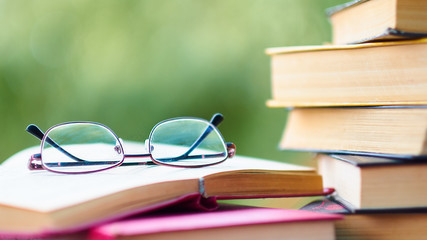 pile of old books lie on the table. home library. concept of vacation from gadgets in nature