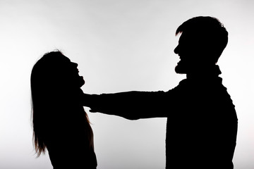 Domestic violence and abuse concept - Silhouette of a man asphyxiating a woman - obrazy, fototapety, plakaty