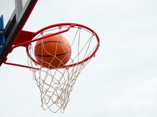 Fototapeta na wymiar Basketball hit the net, the goal is achieved. Basketball street game