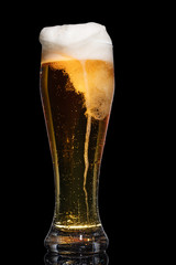 Glass of beer isolated on black background.