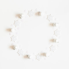 Naklejka na ściany i meble Christmas composition. Wreath made of white snowflakes on white background. Christmas, winter, new year concept. Flat lay, top view, copy space, square
