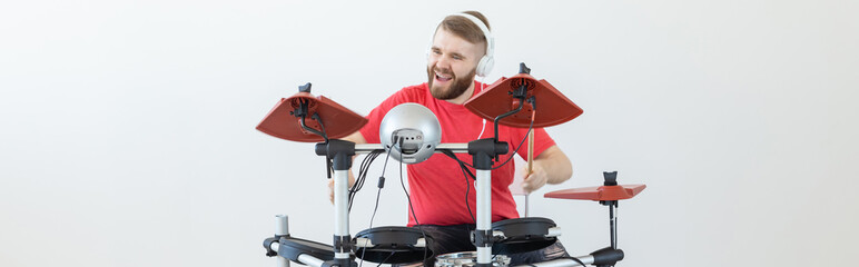 Hobby, music and people concept - Drummer man over the light background