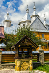 Verkhovyna, Ukraine. Beautiful wooden orthodox church on a background of summer cloudy sky.