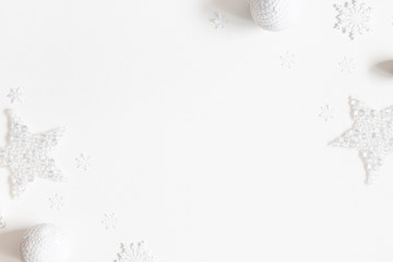 Christmas composition. Frame made of white decorations on white background. Christmas, winter, new year concept. Flat lay, top view, copy space