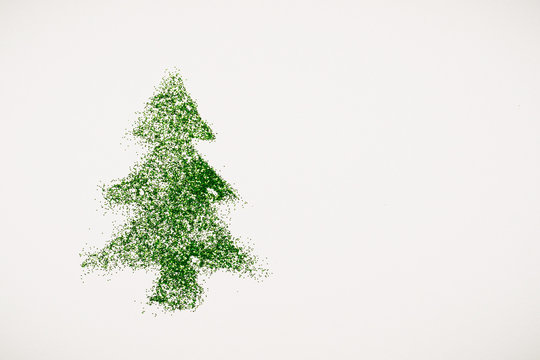 image of a Christmas tree made of sequins on a white background. Top view, flat position