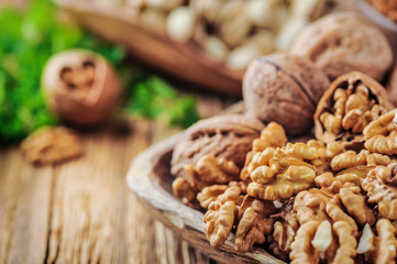 Walnuts on wooden rustic table wit walnut heart. Walnuts kernels.