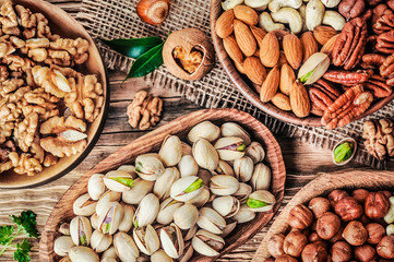 Nuts. Healthy raw food on wooden rustic table. Mix nuts in bowl.