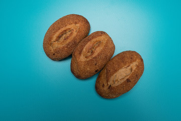 Bun studio image. Fresh buns on a blue background. Buckwheat Bread. Buns made from rye flour. Rye bread.